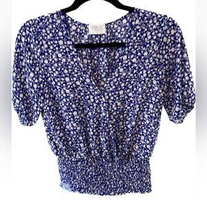 Faux wrap top with a snap closure&smocked at the  waist